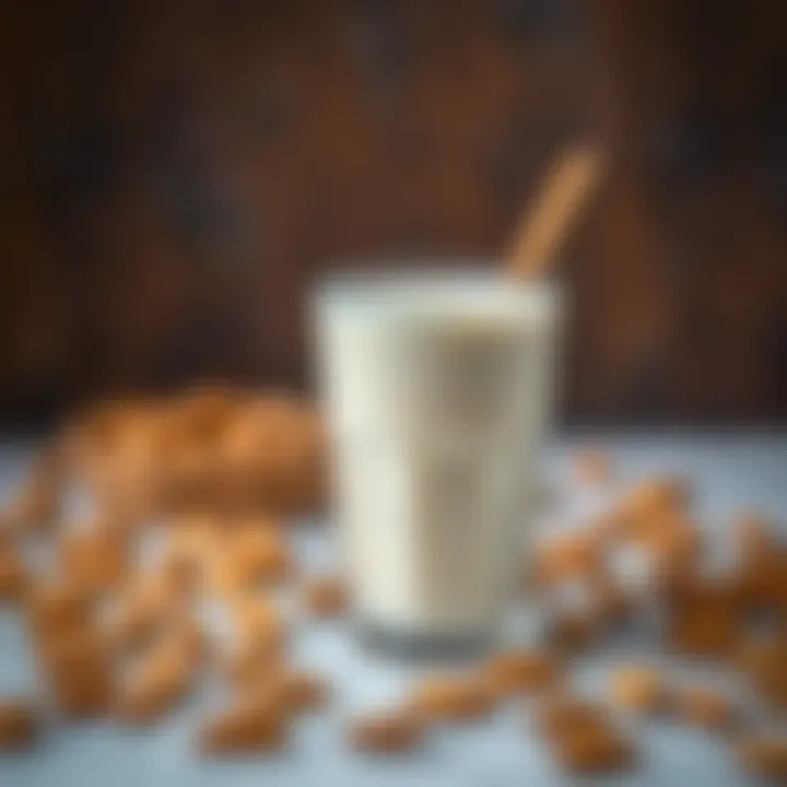 A glass of almond milk with almonds scattered around