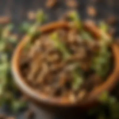 A wooden bowl filled with dried oregano leaves