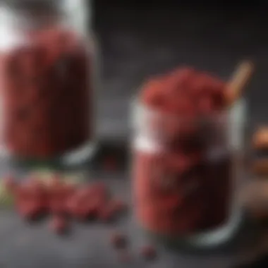 Close-up of high-quality sumac spice in a glass jar.